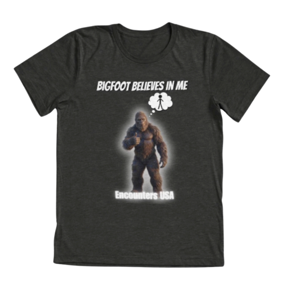 Dark gray tri-blend t-shirt with BIGFOOT BELIEVES IN ME and glowing Sasquatch thumbs up design. Funny motivational cryptid tee by Encounters USA.