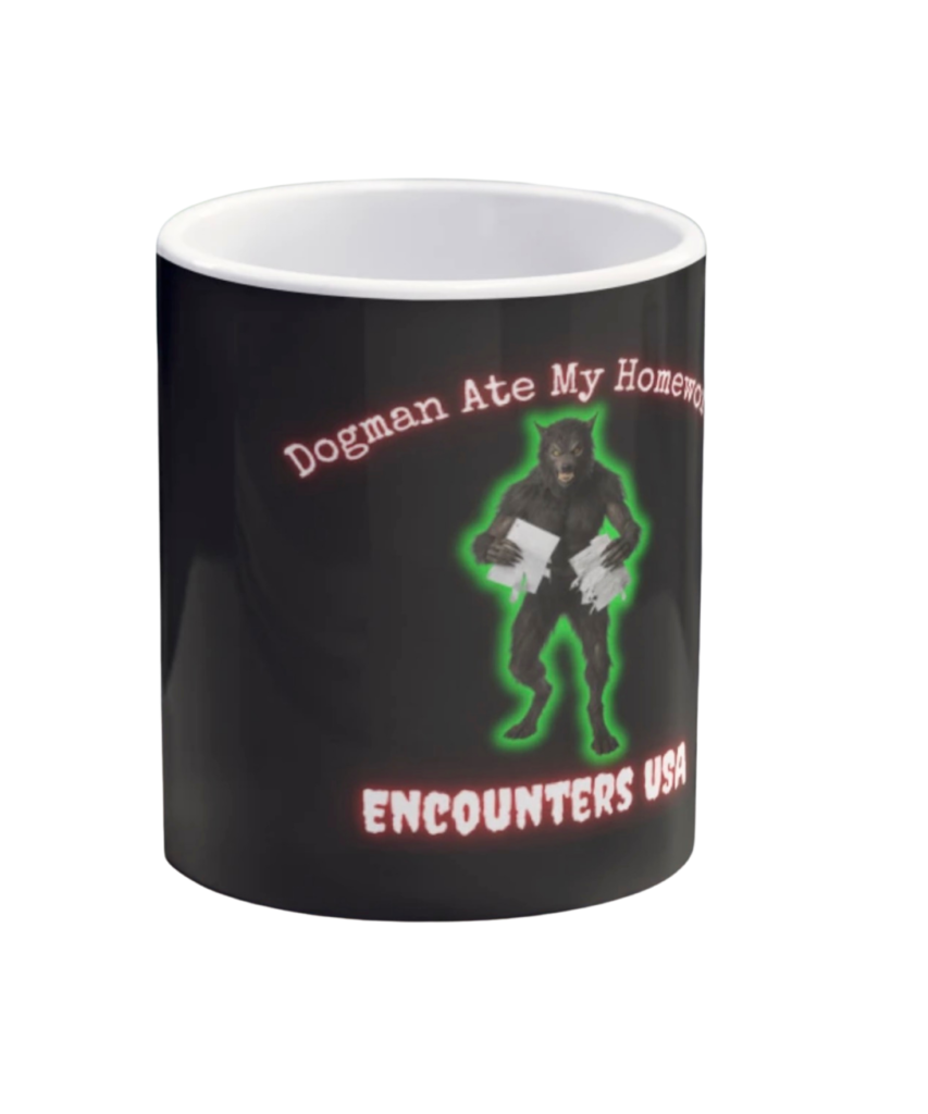 Black coffee mug with glowing green Dogman eating homework and “Dogman Ate My Homework” text, Encounters USA branding.