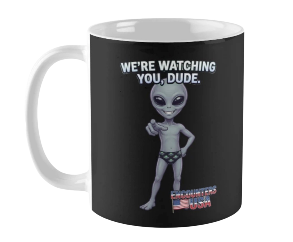 We're Watching You Dude funny grey alien pointing with UFO underwear on black ceramic coffee mug - official Encounters USA merch